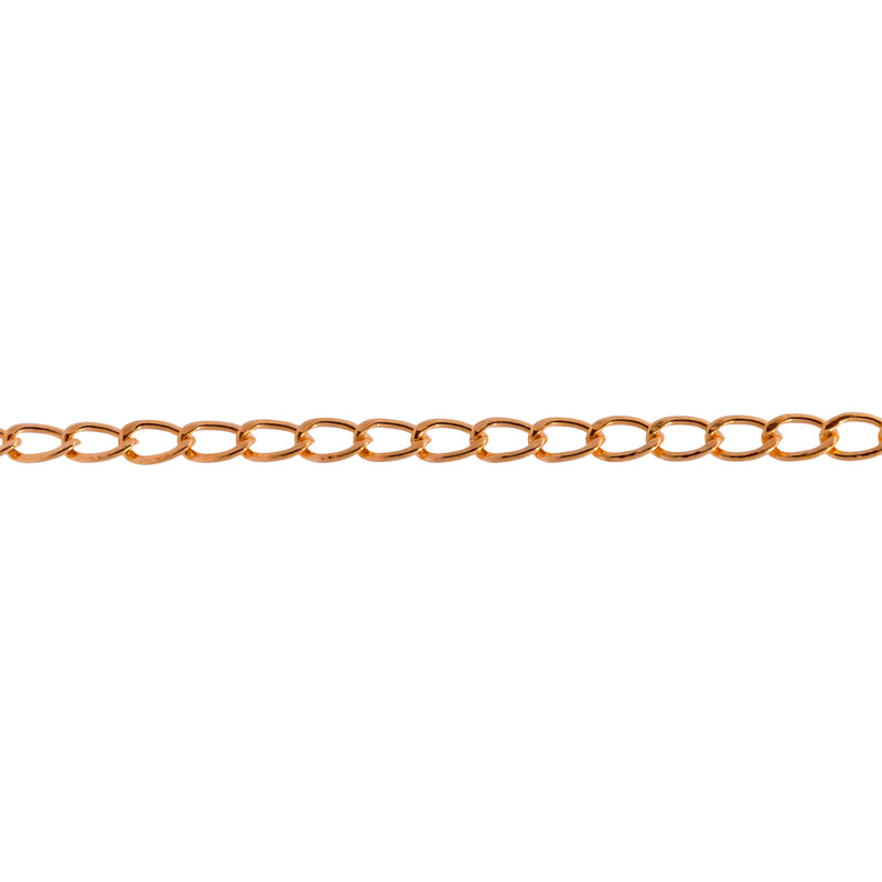 A close-up horizontal view of a gold filled yellow chain for permanent jewelry with flat curb links in a warm yellow-gold tone against a plain white background.