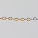 Yellow gold chain with heart-shaped links on a light gray background