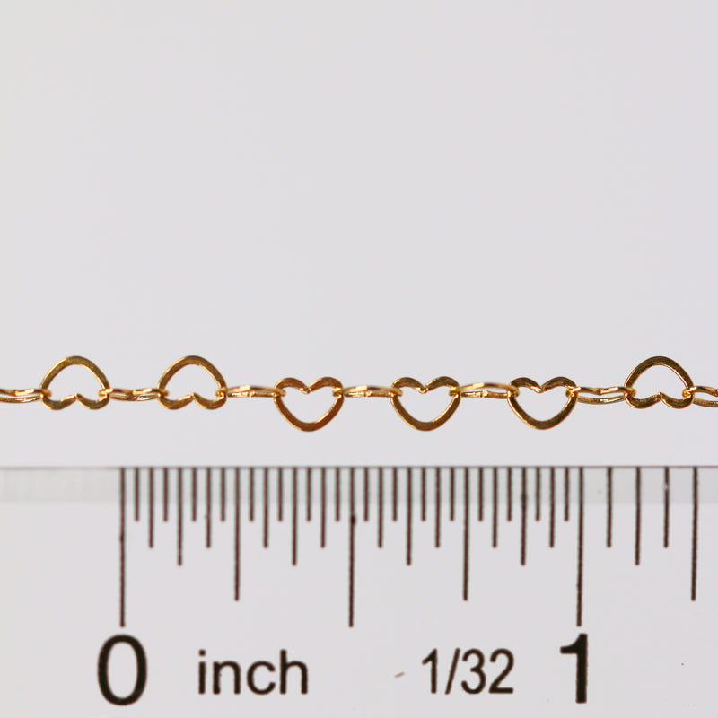 Sunstone certified heart shaped chain laying next to a ruler for measurements