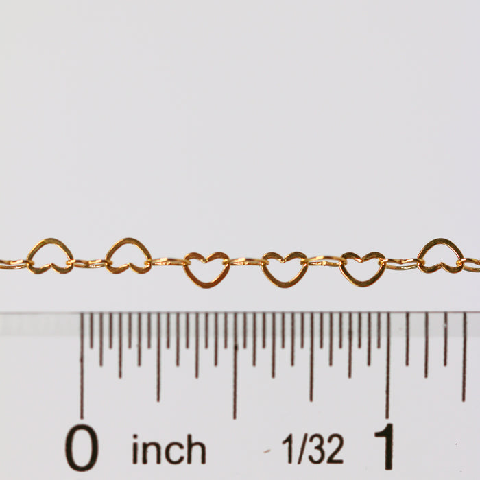 Sunstone certified heart shaped chain laying next to a ruler for measurements