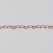 Rose gold chain with flat heart shaped links on a gray background