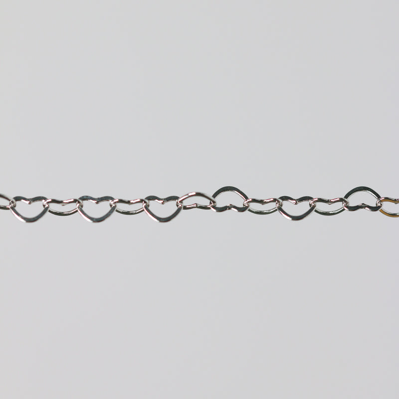 Sterling silver heart-shaped chain on a light gray background
