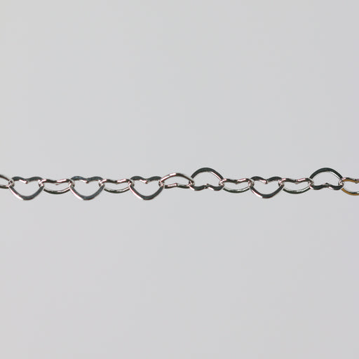 Sterling silver heart-shaped chain on a light gray background