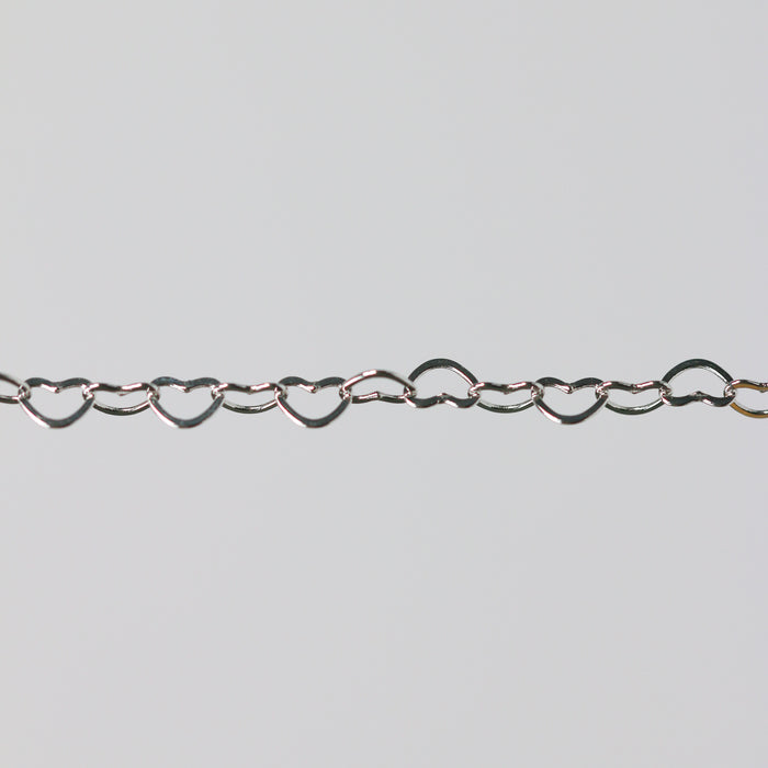 Sterling silver heart-shaped chain on a light gray background