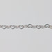 Sterling silver heart-shaped chain on a light gray background