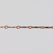 Rose gold dapped bar and link chain for permanent jewelry.