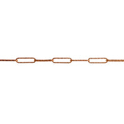 A close-up of a yellow gold chain link featuring elongated oval textured paperclip links in a warm gold tone, shown against a solid white background.