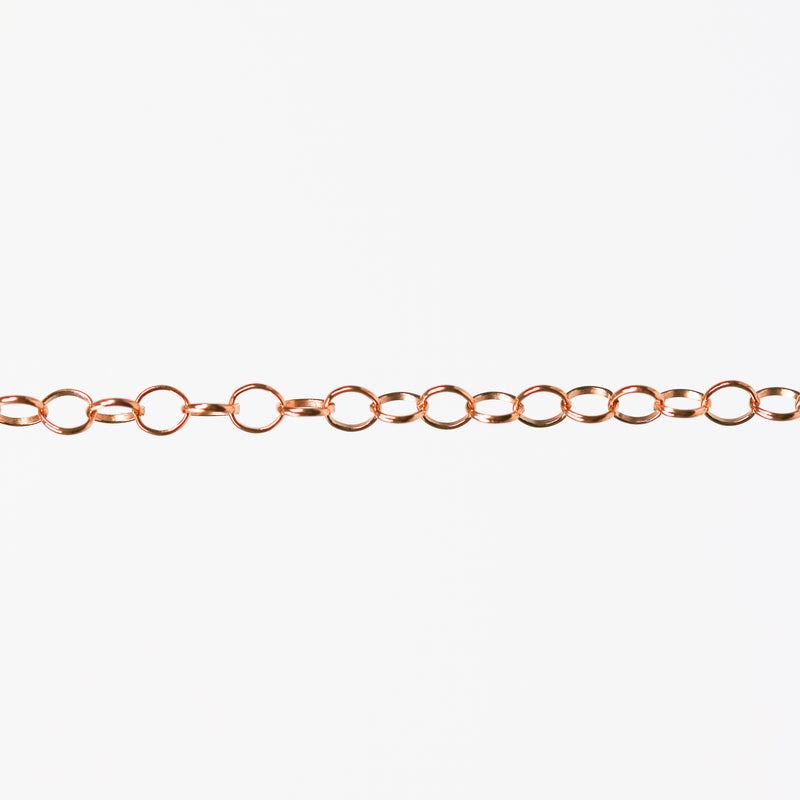 Round linked rose gold chain on a white background