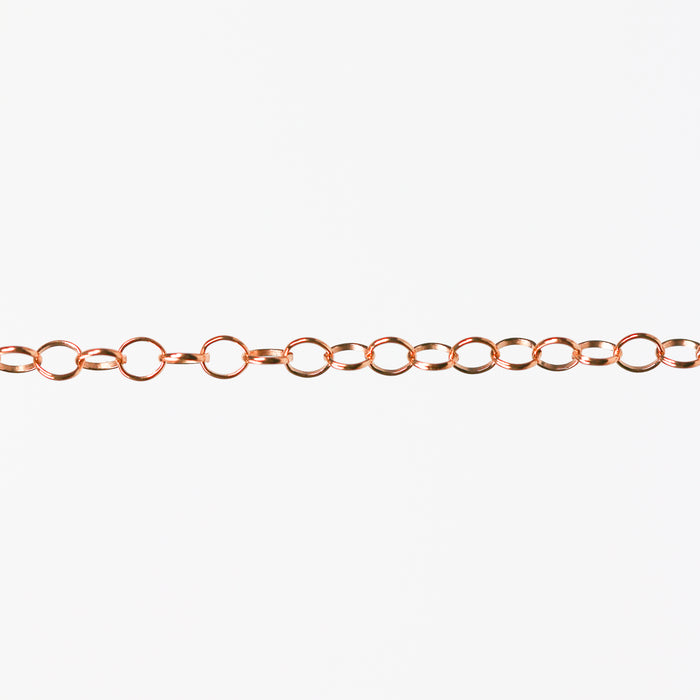 Round linked rose gold chain on a white background