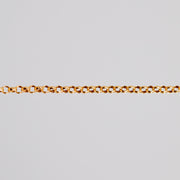 Yellow gold filled rolo chain for permanent jewelry being shown pulled tight across a light background.