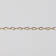 Shiny yellow gold filled chain on a light gray background