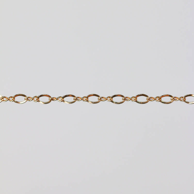 Shiny yellow gold filled chain on a light gray background