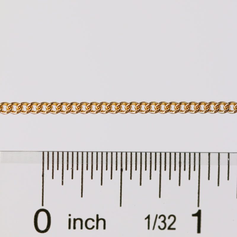 Curb chain being measured next to a ruler to show link size, spacing, and measurements