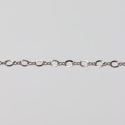 White gold chain with twisted figure 8 links on a light colored background