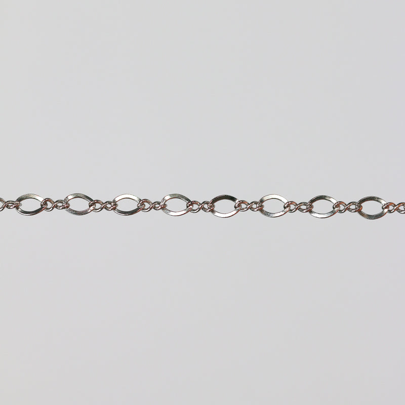 White gold chain with twisted figure 8 links on a light colored background