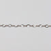 White gold chain with twisted figure 8 links on a light colored background