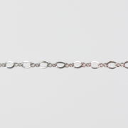 White gold infinity linked pj chain over a light gray background