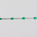 Sterling Silver (SS) cable chain with green enamel beads on it over a light gray background