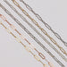 Crinkled paperclip chains stacked in a row showing different colors and metal types