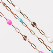 Rose gold chain for permanent jewelry with colorful enamel beads on a white background