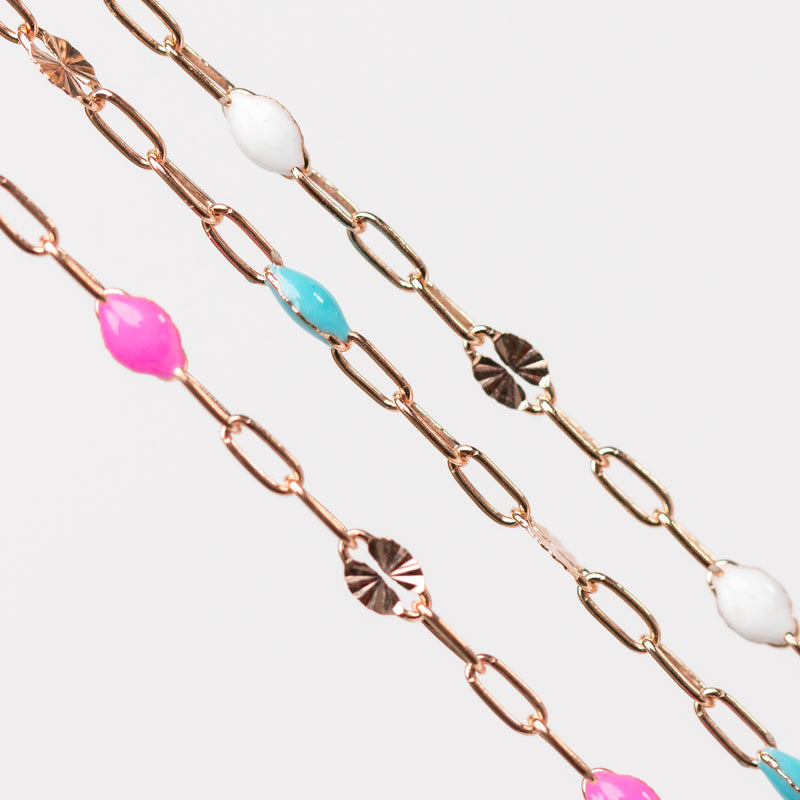 Rose gold chain for permanent jewelry with colorful enamel beads on a white background