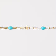 Gold bracelet with turquoise beads made from enamel on a white background