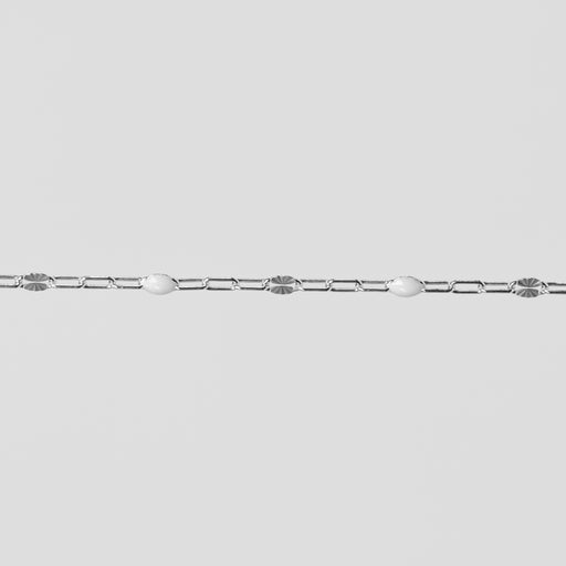 Silver chain on a light gray background with white enamel on it