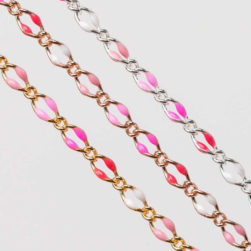 Zoomed in photo of three chains in gold , rose gold, silver. Each have alternating enamel beading in soft pink, hot pink, pinky red, and white.