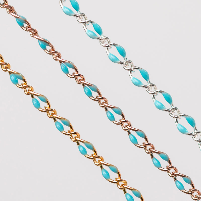 Three chains depicted all with blue enamel. One chain is yellow gold filled, one is rose gold filled, and the last is silver.