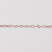 Rose gold filled oval links with hammered texture. Zoomed in on chain with gray background.