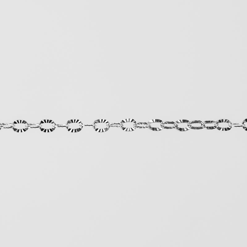 Shiny closeup photo of silver chain with textured oval links.