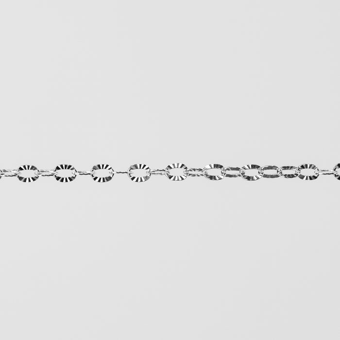 Shiny closeup photo of silver chain with textured oval links. 
