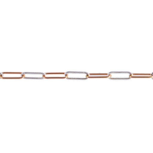 A close-up of a mixed metal chain for permanent jewelry featuring alternating yellow gold and silver paperclip-style links on a plain white background.