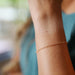 Closeup of the Lucy chain on a woman's wrist