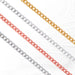 Four jewelry chains in different finishes, silver, gold, and rose gold, laid out flat.