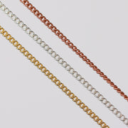 Three pj chains laying side by side in different metal types over a gray background