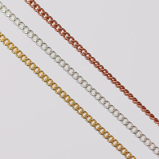 Three pj chains laying side by side in different metal types over a gray background