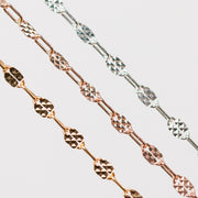 Three chains of different metal types on a light gray background