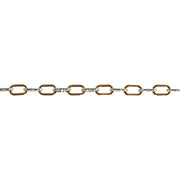 A close up of a mixed metal alternating short link paperclip chain that has gold and silver links.