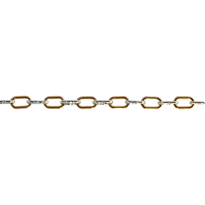 A close up of a mixed metal alternating short link paperclip chain that has gold and silver links.