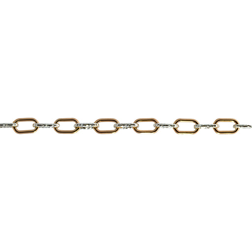 A close up of a mixed metal alternating short link paperclip chain that has gold and silver links.