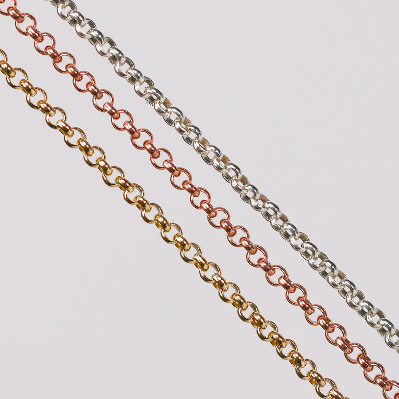 Three metal pj chains with rolo links. One in yellow gold, one in rose gold, and the last one in sterling silver.