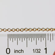 Gold rolo chain next to a ruler to show the size of each loop on the chain.