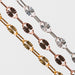 Close-up of three permanent jewelry chains with Hammered Starburst designs on a light gray background
