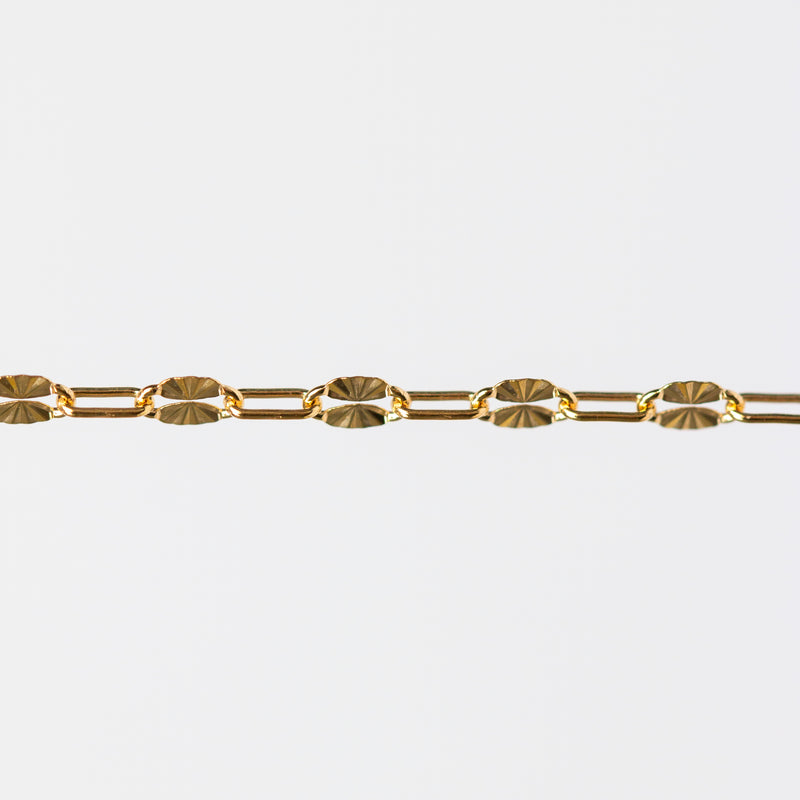 Gold starburst paperclip chain on a white background