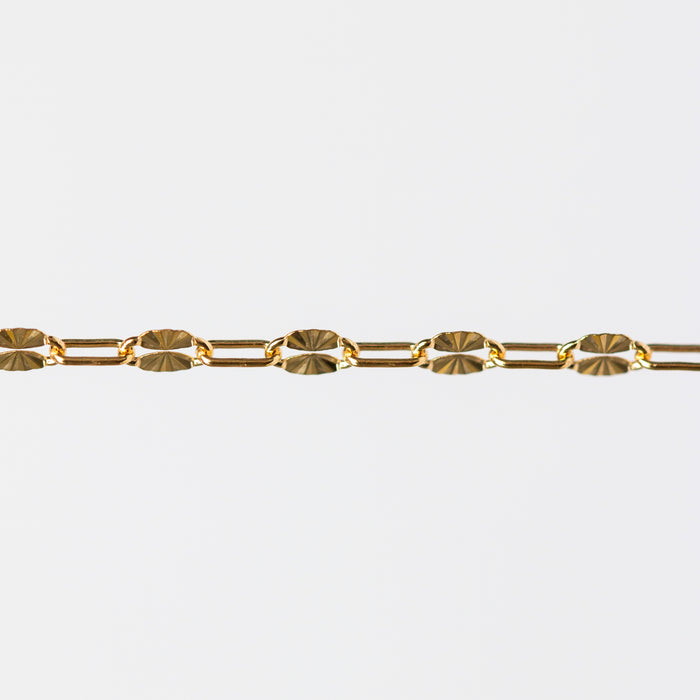 Gold starburst paperclip chain on a white background