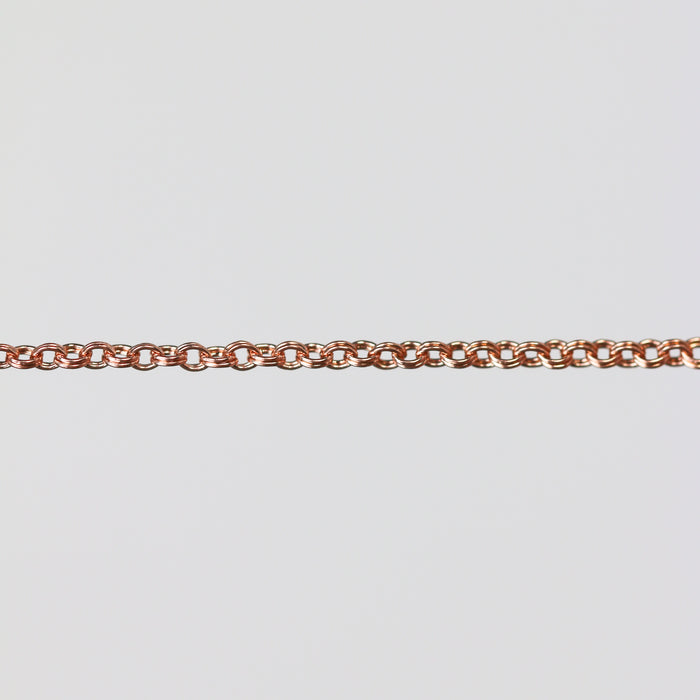 Rose gold double cable chain on a light gray background