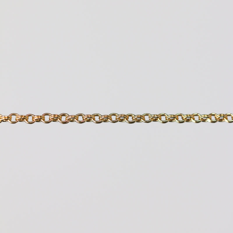 Gold double cable chain on a light gray background