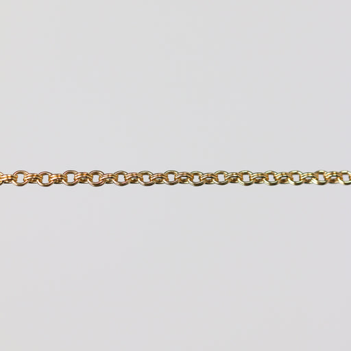Gold double cable chain on a light gray background