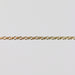 Gold double cable chain on a light gray background